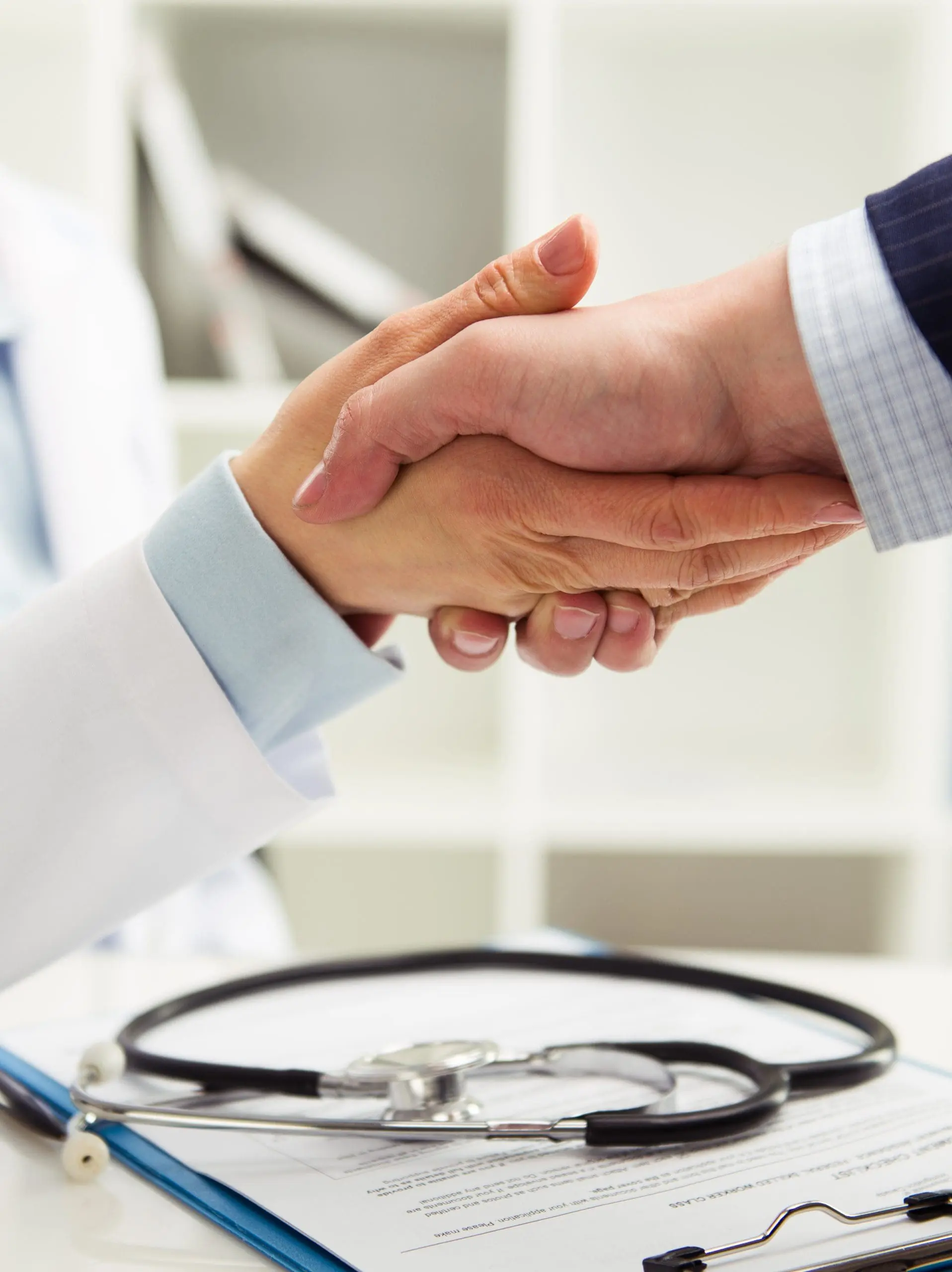 doctor and businessperson handshake