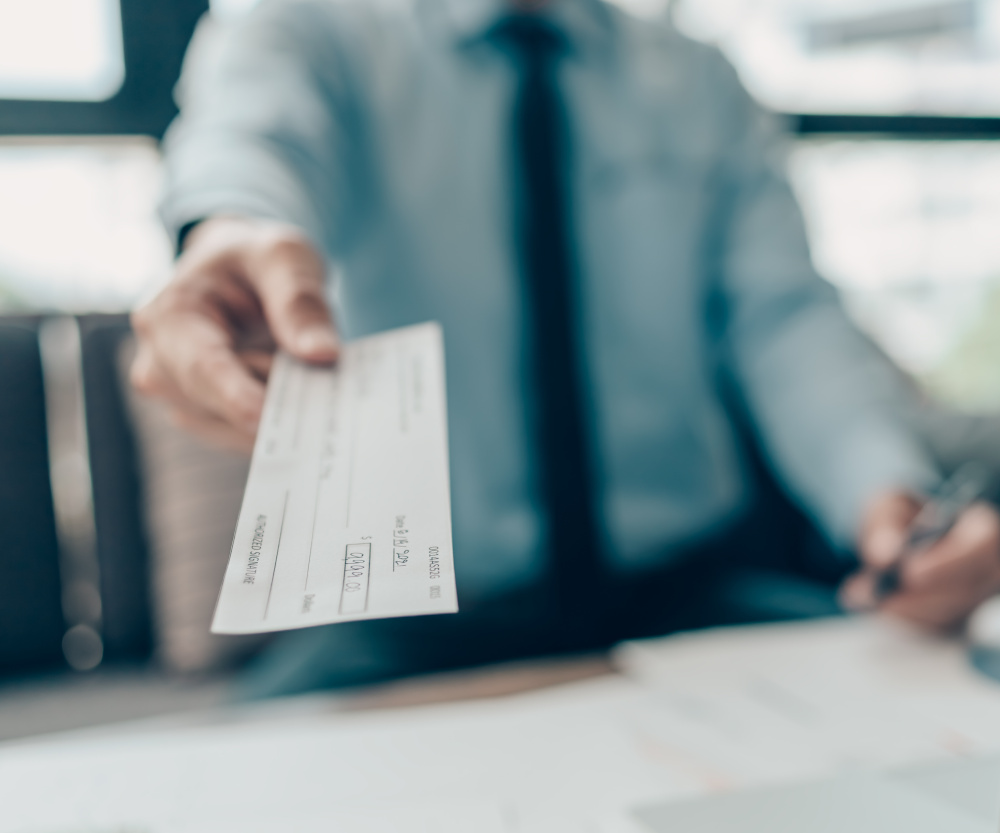 man handing over a check